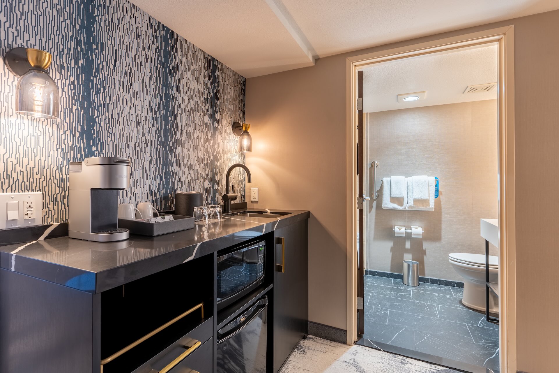 Kitchenette and bathroom in the Deluxe King Bed Room With Jacuzzi at Silver Cloud Hotel Seattle - Broadway.